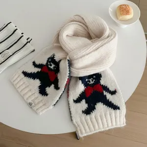 Detailed view of a cute bear jacquard knitted scarf, soft warm material for winter styling.