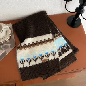 Close-up of winter knitted wool scarf featuring traditional Fair Isle pattern and warm brown tone.