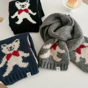 Close-up detail of cute bear jacquard knitted winter scarf, soft warm neck warmer accessory.