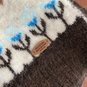 Close up winter knitted woolen scarf with cozy texture and stylish fair isle pattern detail.