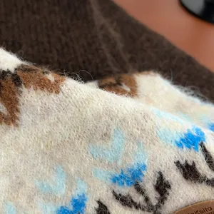 Close-up detail of cozy Fair Isle knitted winter scarf showing soft wool texture and patterns.