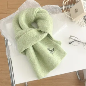 Grüner Strickschal Detail, weicher warmer Stoff mit süßer kleiner Pferde-Bestickung.
