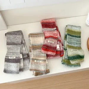 Close-up of colorful striped knitted wool blend scarves detail, soft texture and cozy winter style.