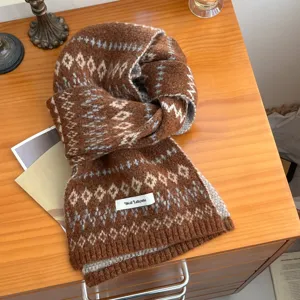 Cozy brown Fair Isle knit scarf detail shot, woolen winter neck warmer accessory close-up.