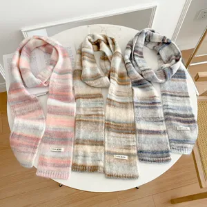 Cozy winter knitted striped scarf for women, soft wool blend warm fashion accessory detail.