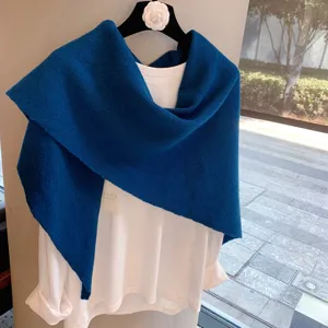 Blue pure wool knitted triangular shawl scarf for women, warm winter fashion accessory detail.
