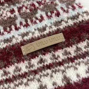 Close-up detail of Fair Isle knitted scarf, cozy winter texture, soft wool blend, warm.