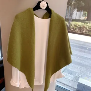 Green wool knitted triangular shawl with white long sleeve top, cozy winter warm fashion.