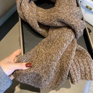 Cozy brown knit scarf detail, soft woolen winter neck warmer with rich textured weave.