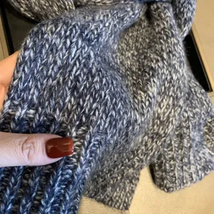 Close-up of thick knitted winter scarf with soft wool blend texture and cozy warmth.