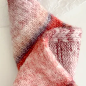 Cozy knitted wool scarf with retro colorful stripes, warm winter accessory for women.