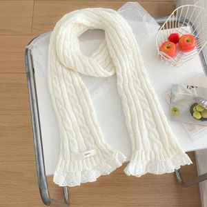White knitted cable scarf with delicate lace trim, cozy winter neckerchief detail view.