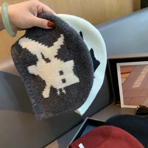 Detailed view of women wool knit beanie winter warm cat pattern hat product texture display.