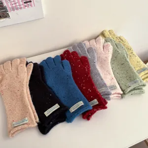 Colorful knit winter gloves detail shot, soft speckled wool handwear for cold weather.