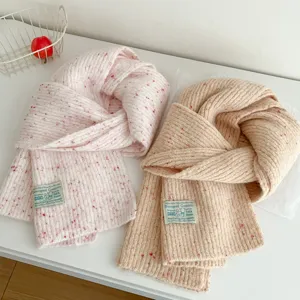 Detailed view of winter colorful speckle knitted scarf, soft warm fabric cozy texture scarf