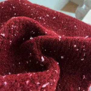 Close-up of dark red speckled knit scarf texture, soft wool material winter detail shot.