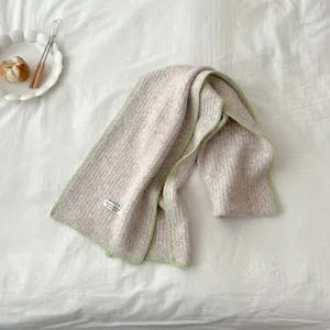 Cozy knit scarf with contrast green edge, minimalist winter warm neckerchief detail.