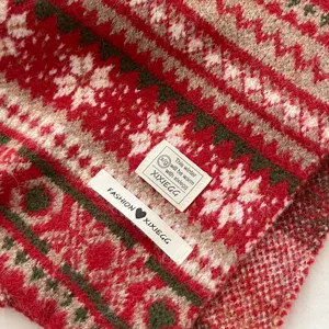 Cozy Fair Isle jacquard knitted winter scarf with retro pattern and decorative label.