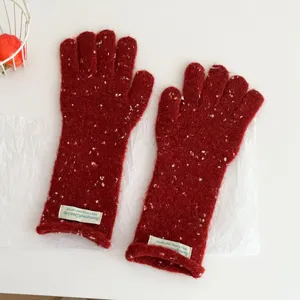 Red speckled knit gloves for women winter, cozy warm wool gloves with decorative labels.