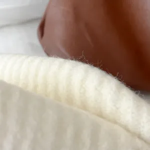 Soft knit winter scarf detail view, warm cream color texture, cozy daily neck warmer accessory.
