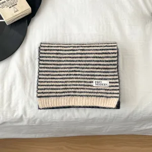 Detail view of the striped knit scarf texture, cozy winter neck warmer and muffler styling.