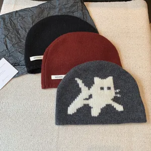 Detail view of 100% wool knit beanie hats for women, autumn winter warm cat pattern caps.