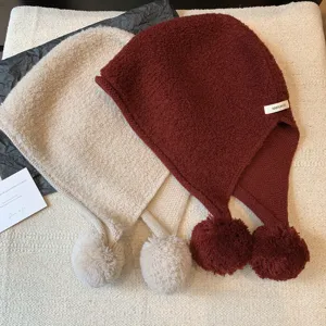 Warm wool knit balaclava hat with fluffy pom-poms, two cozy colors set for winter outdoor wear.