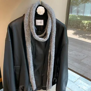 Grey knitted narrow long scarf, minimalist solid color design for women, elegant daily accessory.