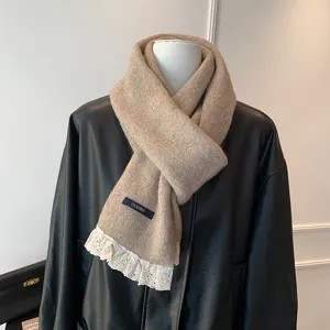 Chic beige knitted scarf featuring delicate white lace trim and cozy design for autumn winter.