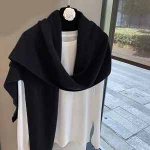 Classic solid color wool knit shawl paired with white long sleeve top for women elegant look.