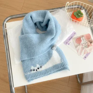 Primo piano dettagliato della sciarpa invernale in morbido filato azzurro con ricamo.