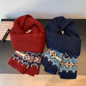 Detailed view of winter knitted Fair Isle scarves in red and blue with cozy geometric patterns.