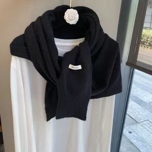 Black knitted wool shawl detail showing fine texture and soft fabric for women spring autumn.