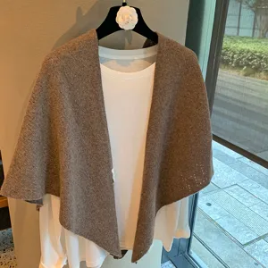 Detailed view of solid brown knitted triangle scarf shawl outerwear, elegant and stylish design.