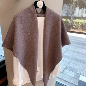 Knit shawl detail display, soft wool blend texture, elegant warm triangular drape styling.