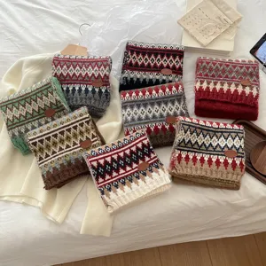 Detailed shot of winter thick warm Fair Isle knit scarves in assorted colors with cozy retro vibe.