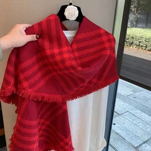 Red plaid scarf detail, winter warm knit shawl with fringe, cozy fashion accessory for women.
