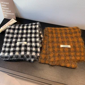 Detail shot of cozy retro plaid knitted scarf texture, soft winter warm woolen fabric material.