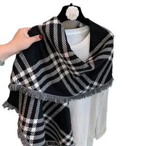 Black and white plaid knitted scarf for women, warm winter shawl with cozy fringe edges.
