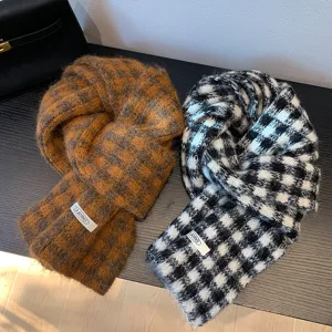 Retro plaid knit scarf detail showing cozy wool texture, classic black-white and brown checks.
