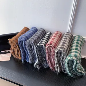 Detailed close-up view of winter cozy plaid knitted scarves in multiple chic colors.