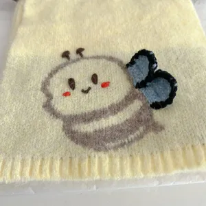 Cute cartoon bee knitted scarf detail, warm winter neck warmer with soft wool fabric.