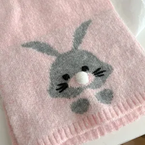 Pink knitted scarf featuring a cute cartoon bunny design with a soft pom-pom nose detail.