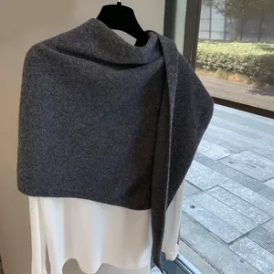 Dark grey wool knit shawl detail, soft texture fabric, stylish autumn layering accessory.