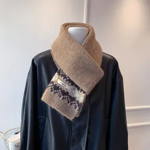 Close-up detail of the Fair Isle knitted scarf, soft winter warm textured fabric pattern.