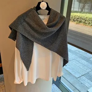 Dark grey knitted triangle scarf shawl detail showing texture and chic draped styling.