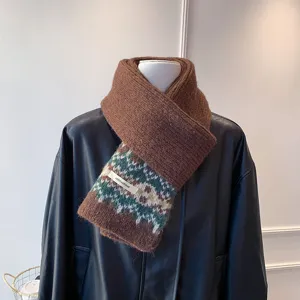 Detailed view of the brown thick knit scarf featuring classic Fair Isle jacquard patterns.