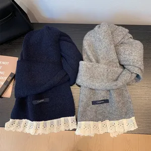 Cozy knit scarf featuring exquisite lace trim detail, ideal for autumn and winter warmth.