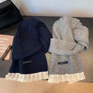 Detail view of winter warm knitted scarf with sweet lace trim, cozy and elegant design.