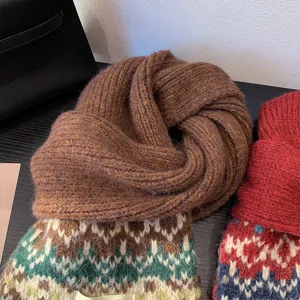 Fair Isle knitted scarf detail, cozy winter wool blend texture, close up display of pattern.